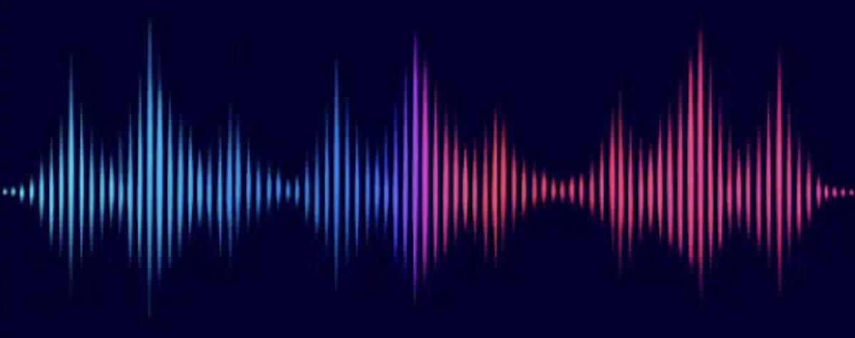 A audio wave that transitions from blue to purple to pink on a dark background.
